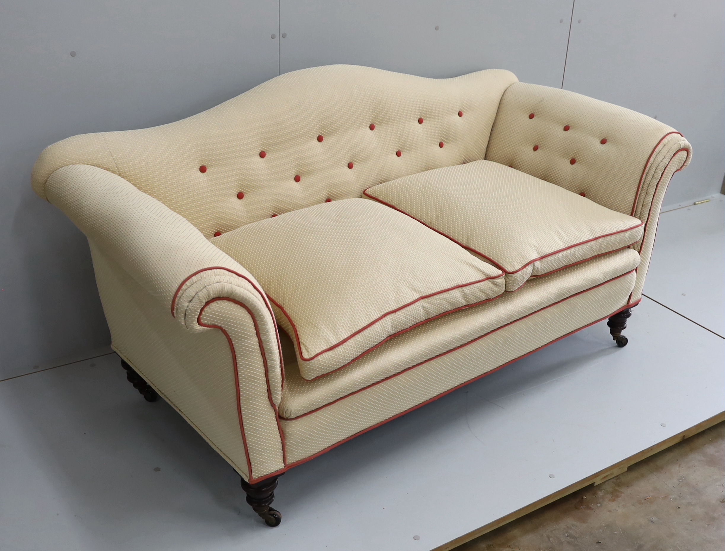 A late Victorian upholstered scroll arm two seater settee, length 176cm, depth 78cm, height 84cm
